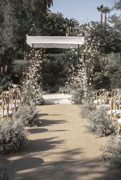 an outdoor ceremony setup with chairs and flowers