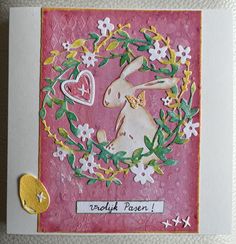 a close up of a card with a rabbit on it's face and flowers in the background