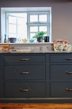 a kitchen with an oven, counter top and window in it's center area