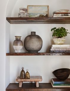 some shelves with vases and books on them