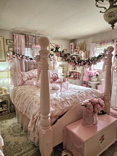 a bedroom decorated in pink and white with lots of flowers on the bed, dressers and nightstands