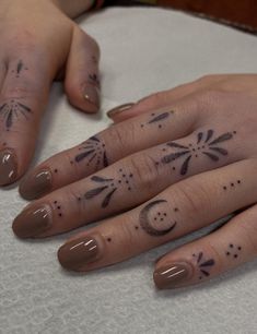 two hands with tattoos on their fingers