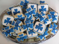 blue and white decorated cookies on a silver platter