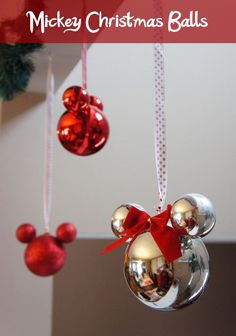 mickey mouse christmas balls hanging from the ceiling in front of a red and gold ornament