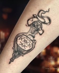 a tattoo on the leg of a woman with a bottle in it's hand