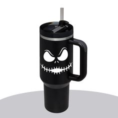 the jack skellingy mug is black with white eyes and fangs on it's face