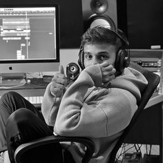 a man wearing headphones sitting in front of a computer