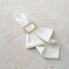 a white napkin with a square buckle on it