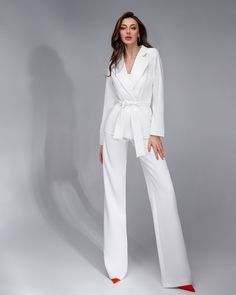 Fabric: Crepe Composition: cotton 65%, polyester 35% Included: jacket, corseted crop top, wide-leg pants and belt Wide-notched lapels High-rise pants Pants length (inseam): 95cm/ 37.5in Color: Black, white, red, camel Wedding Bridal Suit, Bridal Suit, Belted Pants, Long Trousers, White Belt, 3 Piece Suits, High Rise Pants, Trendy Accessories, Black White Red