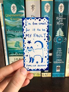 a hand holding up a small card that says i'm too small for it to be my fault