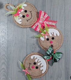 two christmas ornaments made out of burlocks on a wooden surface with ribbons and bows