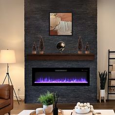 a living room with a fireplace and couches in front of the fire place that is built into the wall