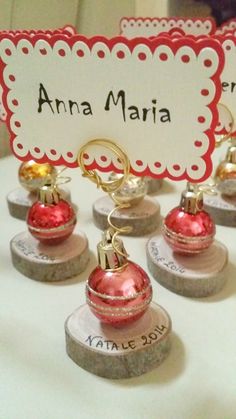 small christmas ornaments are on display with a name tag