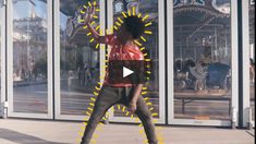 a man standing on top of a skateboard in front of a glass building with yellow arrows