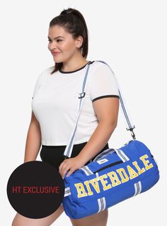 a woman holding a blue duffel bag with the words ht explosive on it