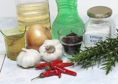 spices and herbs are on the table next to bottles, pepper, garlic, lemonade