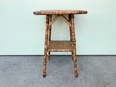 a small wooden table sitting on top of a cement floor