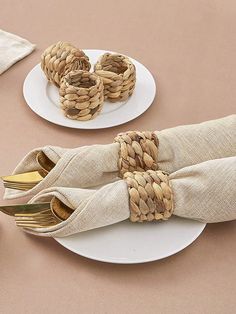 the napkins are wrapped in twine and placed on top of each other with gold forks