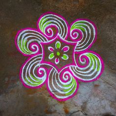 a colorful flower design is on the ground