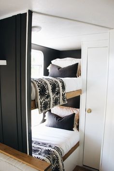 bunk beds are lined up in the corner of a room with black and white decor