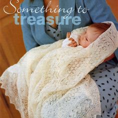 there is a woman holding a baby wrapped in a blanket and wearing a blue cardigan