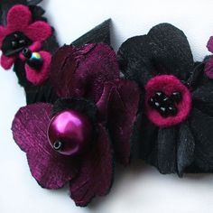 Pink and black fabric flowers combine beautifully on this elegant ribbon necklace. The dark magenta shines against the black on this stylish statement necklace. This really is a piece of special occasion jewellery which would be wonderful for a big night out or an exceptional day. For instance, a pink and black wedding can be a chic affair. These colours contrast beautifully against a backdrop of white. This fancy necklace is glamorous, striking and feminine so it would be perfect of this event. Party Necklaces With Handmade Flowers, Handmade Flower Necklaces For Party, Pink Handmade Flowers Necklace For Party, Black Ribbon Necklace For Party, Flower Ribbon Necklace, Black Flower Necklace For Party, Black Ribbon Necklace, Black And Pink Wedding, Black Ribbon Choker Necklace