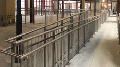 the inside of a building with metal railings and doors on either side of it