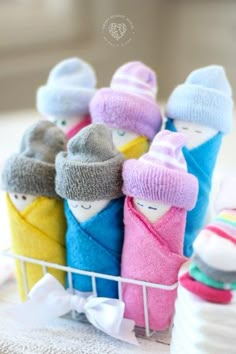 small towel dolls are sitting in a basket