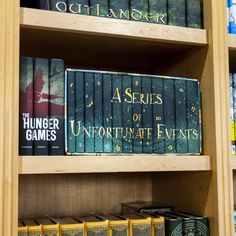 several books are on the shelves in a book store, including asterisks of unfortunate events