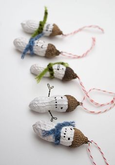 three small knitted mice are on a string