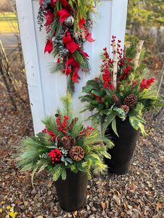 two planters with christmas wreaths on them