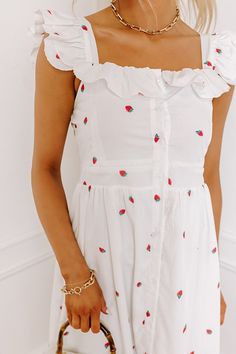 - This adorable dress is as sweet as it gets! - Fully lined material with red and green hued strawberry print - A square cut neckline with ruffle detailing on the front and an elastic back - Short flutter sleeves - A buttoned front that ends just above a ruffled hemline - A flattering silhouette that ends in a ruffled midi length hemline Strawberry Kisses, Strawberry Print, Square Cut, Flutter Sleeves, Flutter Sleeve, Midi Length, Cute Dresses, Button Downs, Elastic