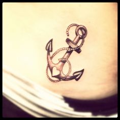 an anchor tattoo on the side of a woman's stomach