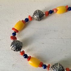 "Yellow glass bead necklace 3 large silver beads with raised design Small red and blue beads 20\" long Yellow beads .5\" long , .26\" wide Condition - very good vintage" Red Fringe, Hippie Necklace, Red Beads, Necklace Boho, Red Bead, Glass Bead Necklace, Blue Beads, Boho Necklace, Small Designs