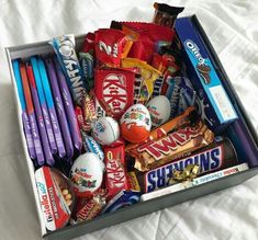 a box filled with candy on top of a bed