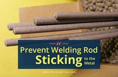 a stack of sticks sitting on top of a cardboard box next to a sign that says, prevent welding rod sticking to the metal