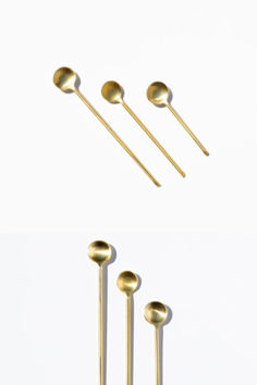 three gold spoons and two forks on a white background, with the top one being used as an appliance