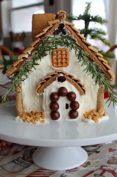 a white plate topped with a gingerbread house