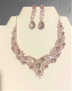 "Bold Pink Crystal Statement Jewelry Set , Pink Crystal Bib Choker Necklace and Earrings Set , Bridal Crystal Set , Pageant Jewelry Set Beautiful Necklace is a little over 19\" + 2 1/2\" extension . Matching Earrings are almost 2 \" long  Silver Necklace is 17 \" + 2 \" ext I do not accept returns. Sales are final !" Pink Crystal Jewelry Sets For Wedding, Pink Crystal Necklaces For Wedding, Pink Crystal Jewelry Sets With Rhinestones, Pink Crystal Costume Jewelry Necklace, Pink Crystal Glamorous Necklace, Pageant Jewelry, Pink Jewelry Set, Long Silver Necklace, Pretty Necklaces