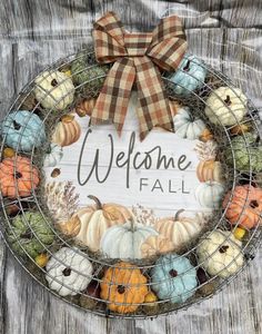 a welcome fall wreath with pumpkins and gourds