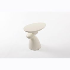 a white table sitting on top of a white floor