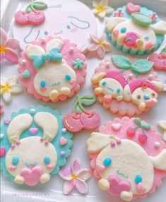 there are many decorated cookies on the tray