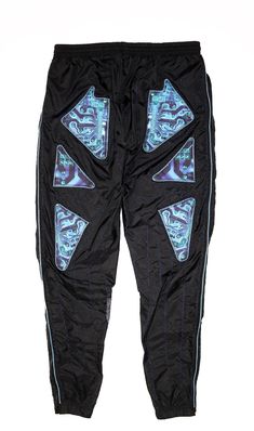 Reclaimed nylon trousers; 100% Nylon Custom dogwood denim circuit board print cutouts; 100% CottonContrast metallic blue zippers; 100% Nylon, blue metallic teethMetallic blue barbed-wire embroidery; 60% polyamide/40% PolyesterGenesis Cultura Collection designer commentary:Inspired by throwaway computers and outdated technology, disposed of in excessive amounts to make room for new progressions in mainstream tech culture. The concept behind this look was to coincide the weight of the earths pollu