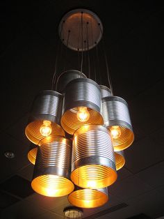 a chandelier made out of tin cans hanging from the ceiling