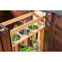 an open cabinet with pots and pans in it