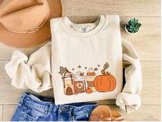 If you're in need of a Fall sweater that shows your passion of Coffee and Pumpkins then this is the right sweatshirt for you Pumpkin and Coffee Sweatshirt, Halloween Sweatshirt, Cute Fall Shirt, Fall Sweatshirt for Women, ,Fall Shirt, Spooky Season Disclaimer ~ - The Prints may appear smaller depending on the shirt size ordered - Colours in listings may slightly vary depending on what device you are using - Please contact us if you have any questions or concerns! A sturdy and warm sweatshirt bou Fall Basics, Halloween Kunst, Turkey Shirts, Pumpkin Sweatshirts, Coffee Sweatshirt, Autumn Coffee, Pumpkin Shirt, Gildan Sweatshirts, Thanksgiving Shirts