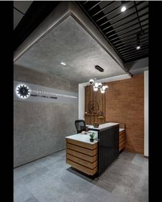 the interior of an office building with a desk and chair in front of a brick wall