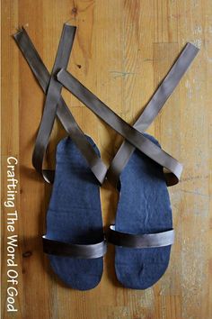 two pairs of blue slippers are tied up to the floor with straps on them