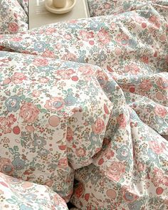 the comforter is made up with pink and blue flowers