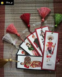 some cards with tassels on top of them